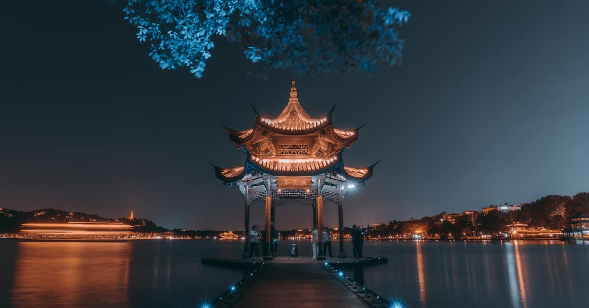 hangzhou west lake - traditional pavilion by the water at dusk
