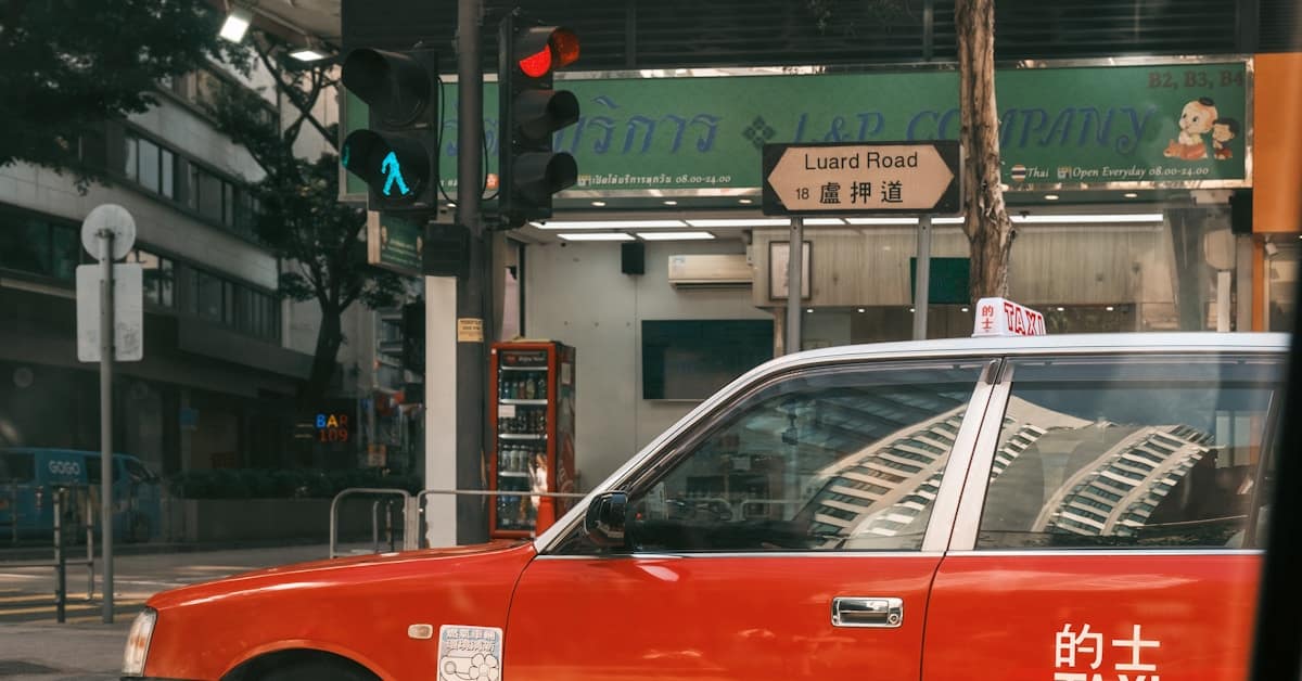 didi china - red taxi driving on city street