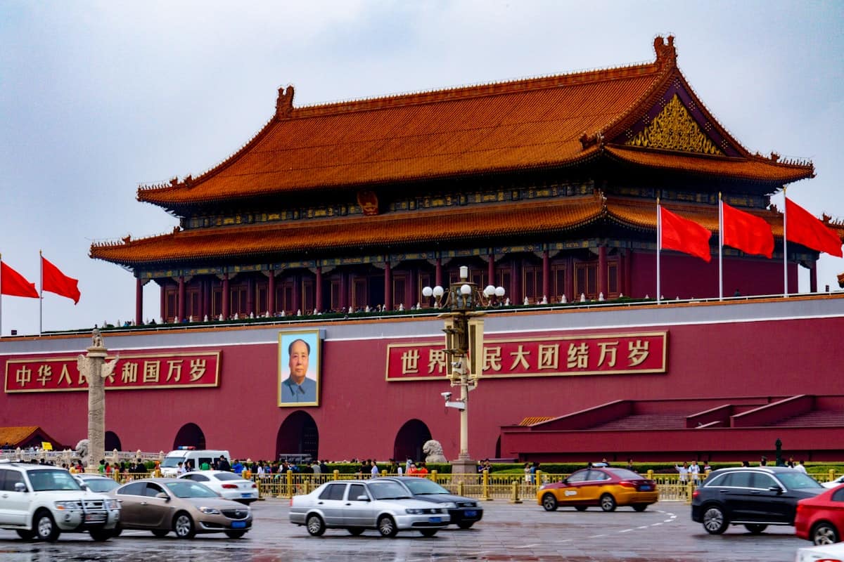 beijing first time - Tiananmen gate seen from across the square with red walls and the Mao portrait