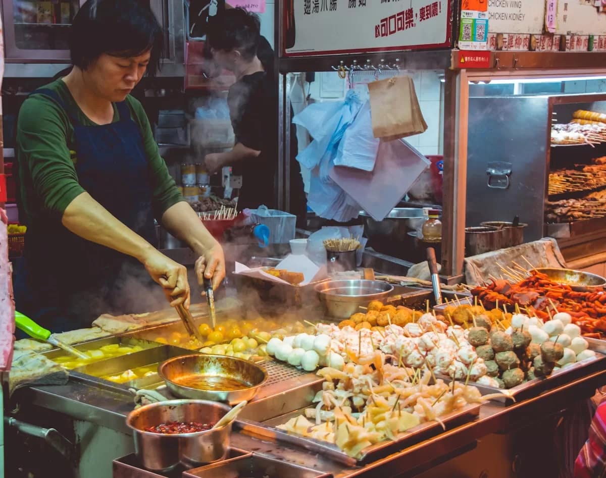 Vibrant street food stall with sizzling snacks at Xi'an Muslim Quarter night market
