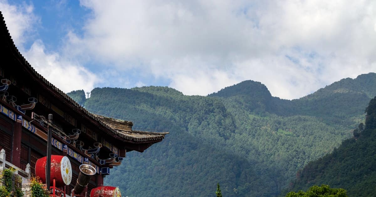 lijiang jade dragon snow mountain - temple building with mountain backdrop