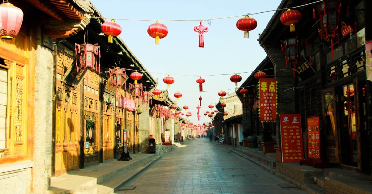 lijiang old town - traditional street lined with shops and red lanterns at night