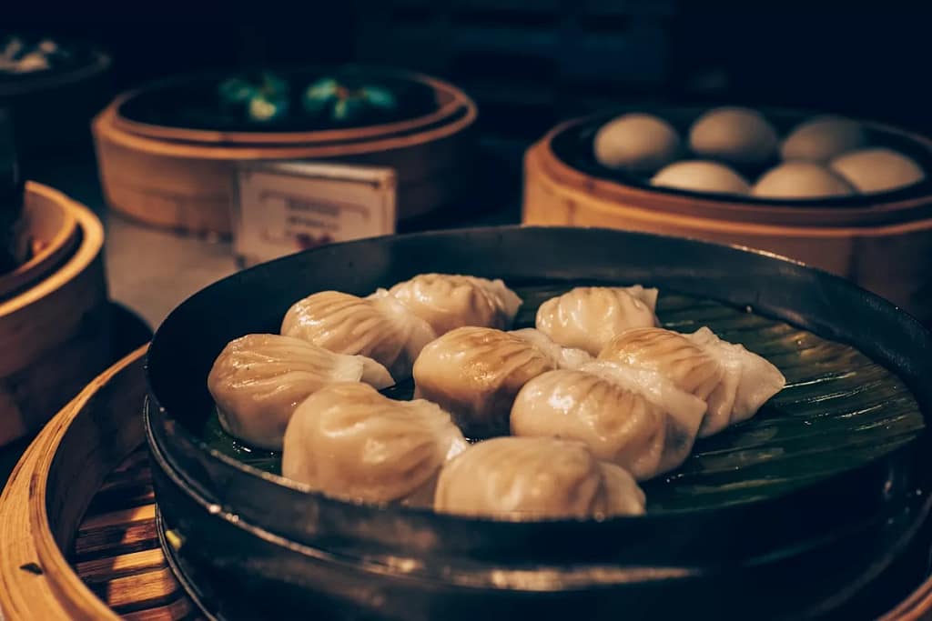Vibrant Chinese street food market at night with steaming stalls