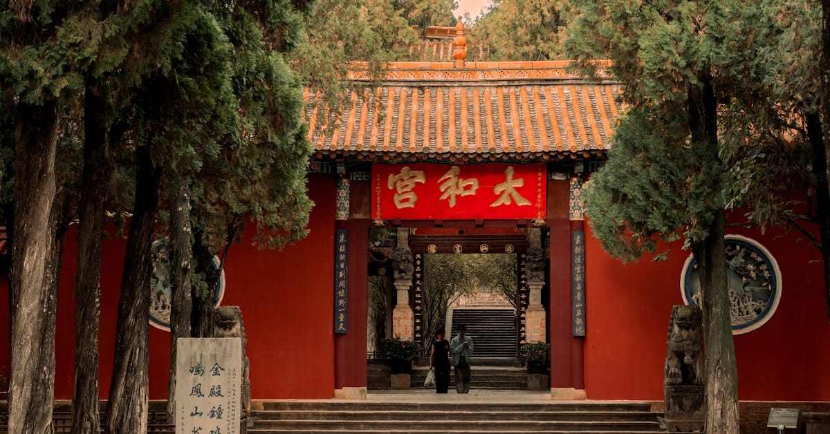 Kunming Yunnan - traditional red building surrounded by trees in a park