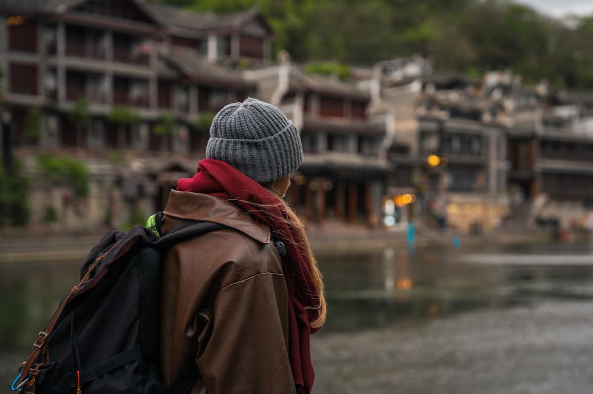 Solo female traveler exploring traditional Chinese streets with backpack