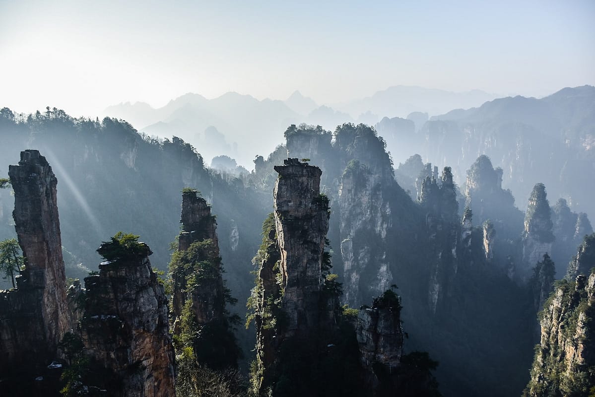 Dramatic karst mountain landscape with river winding through valleys in China