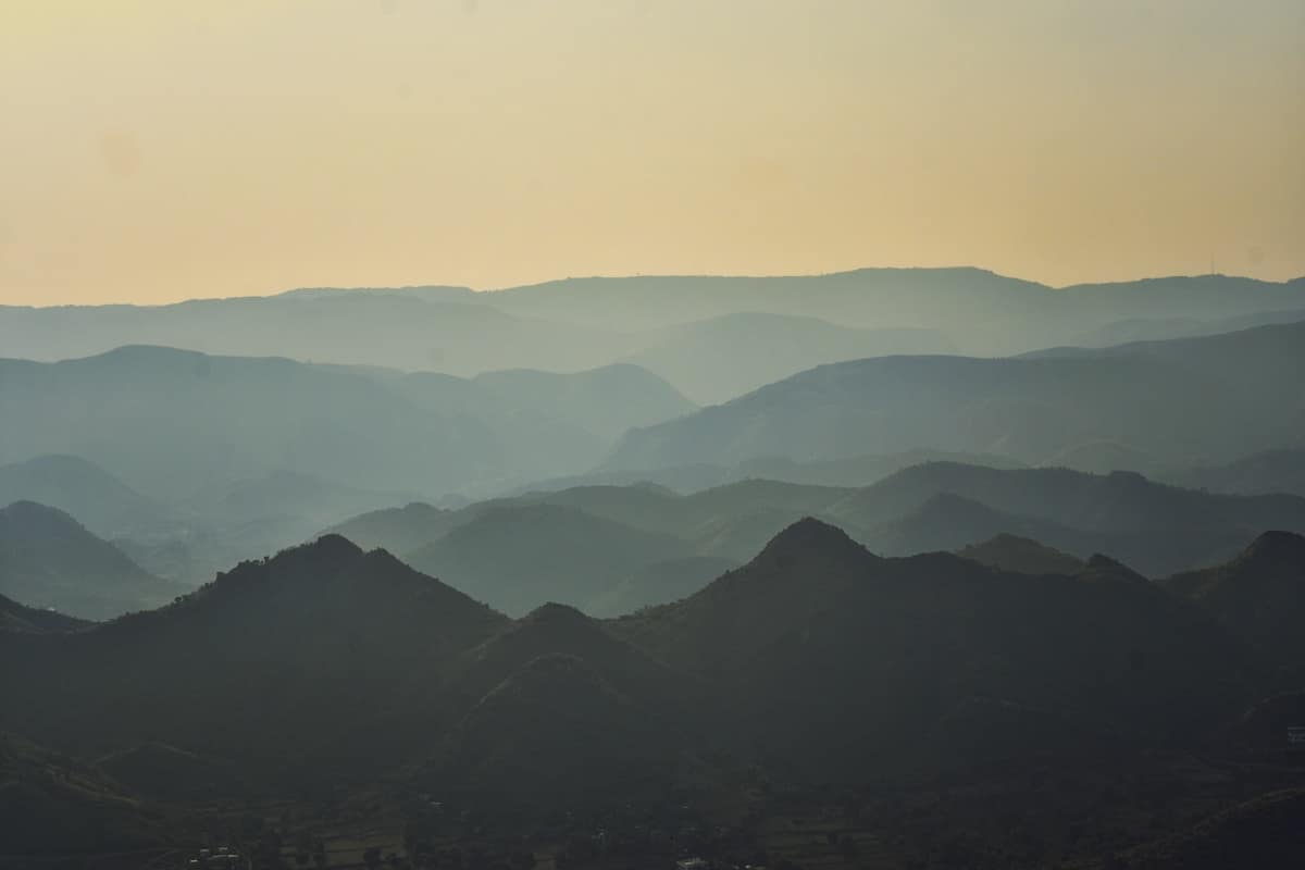 Layered mountain ranges stretching into misty distance in rural China