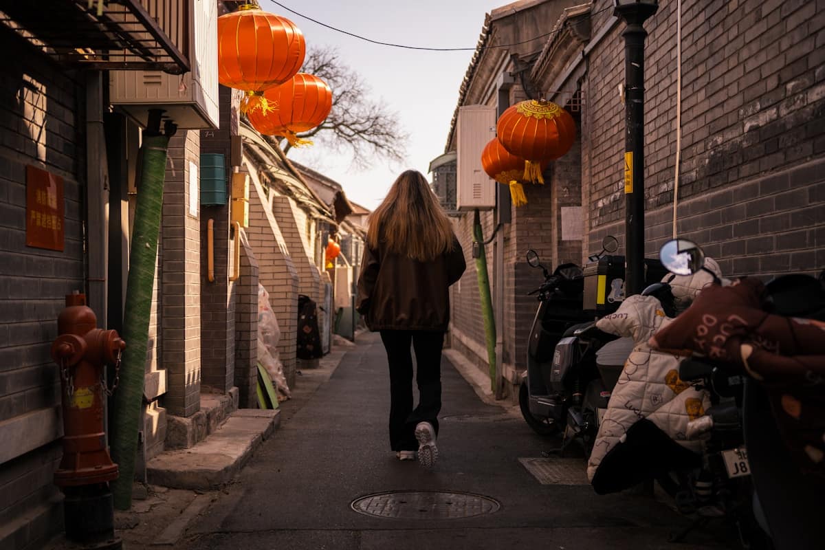 Traveler walking through vibrant Chinese street market with local shops