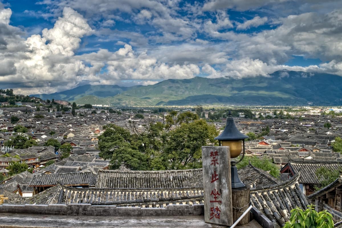 Rooftop bars with panoramic view of Lijiang old town at dusk with red lanterns Yunnan China