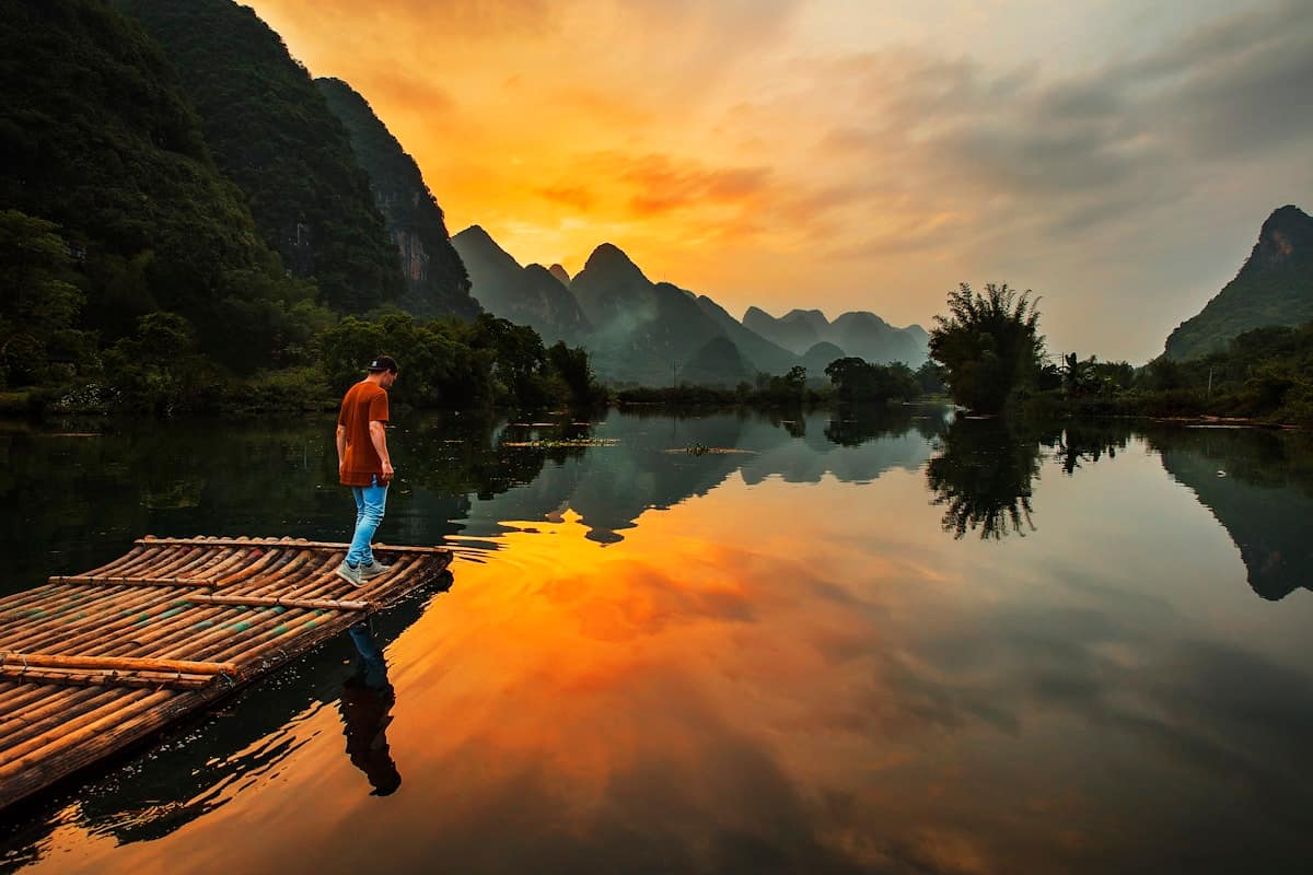 Dramatic limestone karst peaks rising above the Li River in Yangshuo Guilin China