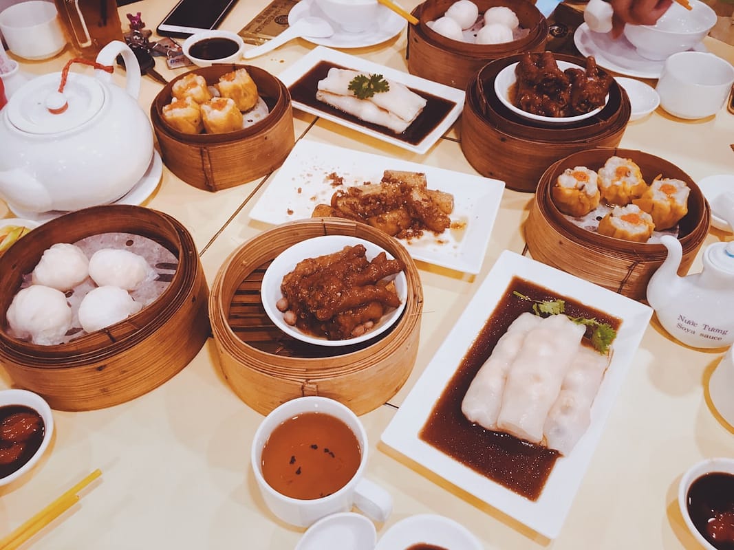 Chinese dumplings in bamboo steamer with dipping sauce