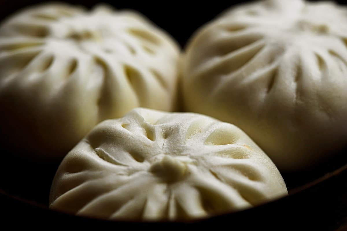 Freshly steamed Chinese buns with traditional dim sum presentation