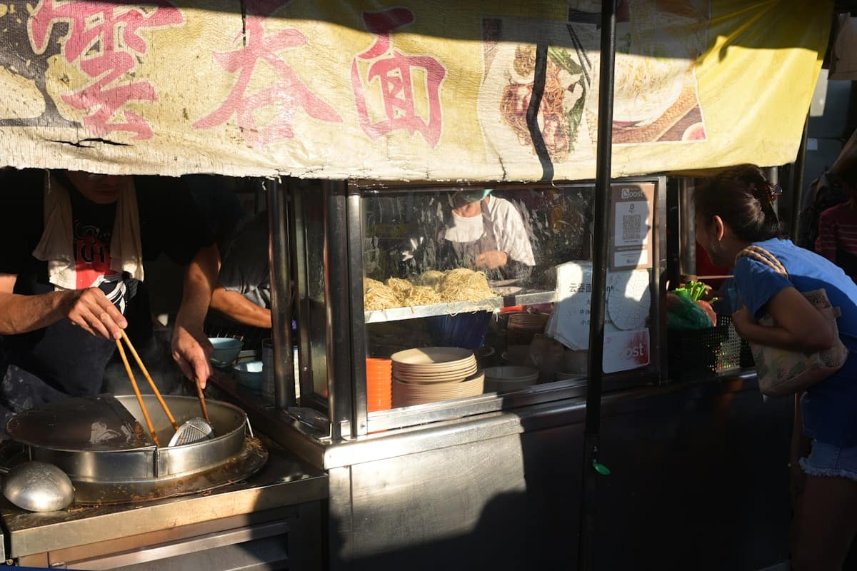 Fresh hand-pulled noodles being prepared at a Xi'an street food market