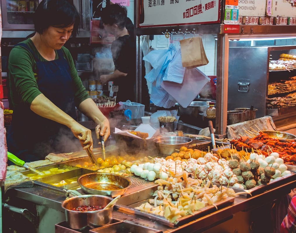 Vibrant street food stall with sizzling snacks at Xi'an Muslim Quarter night market