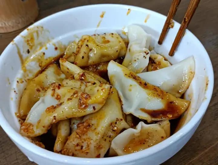 Zhong Shui Jiao: A type of Chinese dumpling originating from Sichuan province, typically filled with pork and served in a clear spicy broth. The dough is made from rice flour, giving it a unique texture compared to traditional wheat-based dumplings.