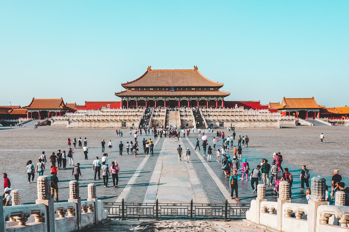 beijing first time - Forbidden City crowds walking through the central courtyard on a clear day