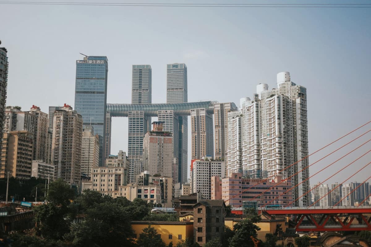 china in july - dense Chongqing skyline above the river in summer heat