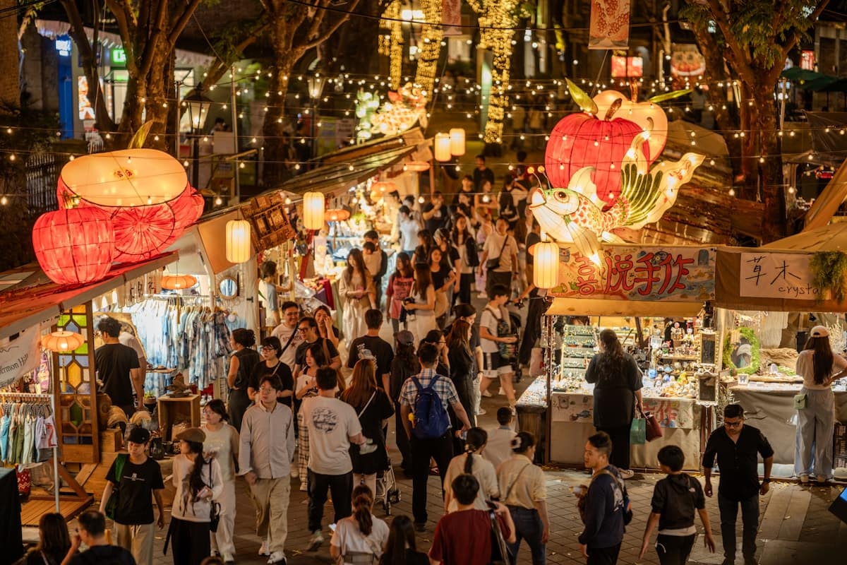 china in july - crowded night market with food stalls and red lanterns