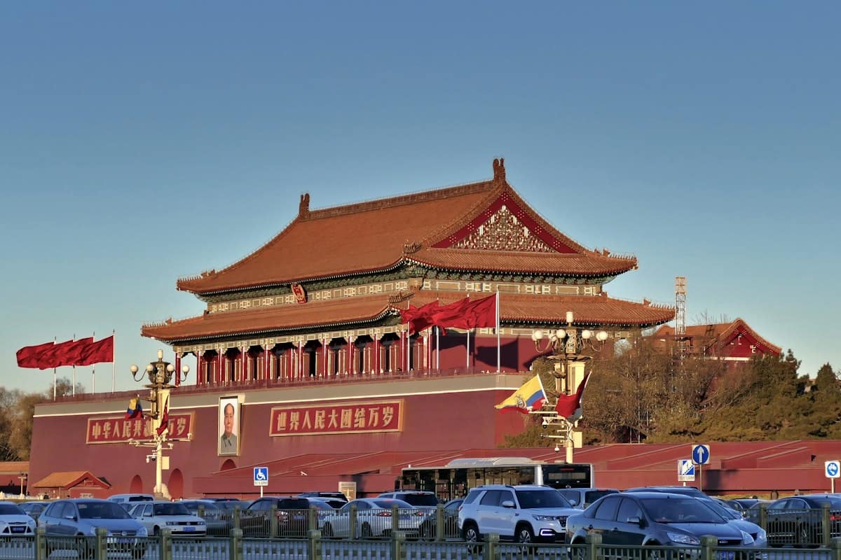 forbidden city red wall - shaded wooden archway