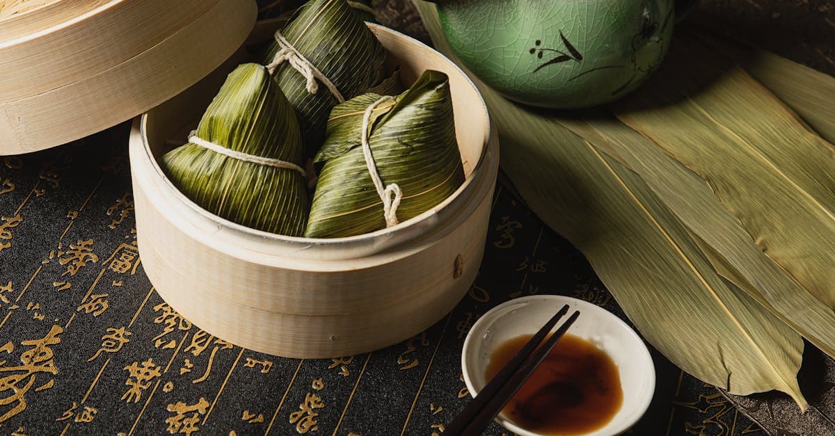 zongzi rice dumpling - sticky rice wrapped in bamboo leaves served with soy sauce