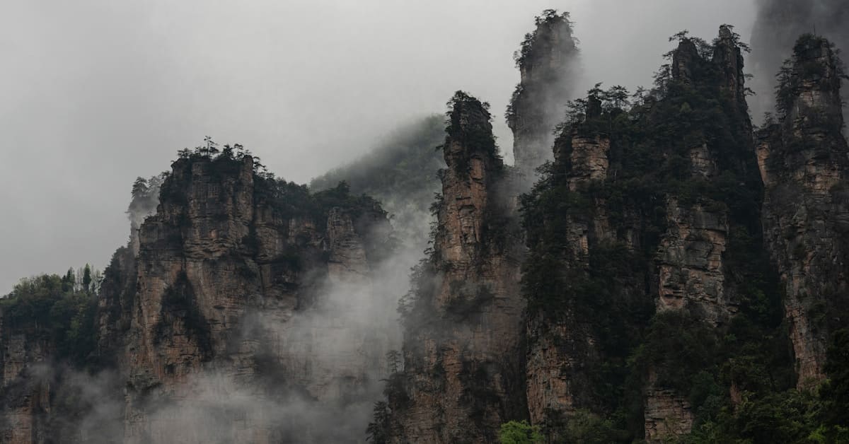 zhangjiajie fog - mountain covered in fog and mist with atmospheric haze