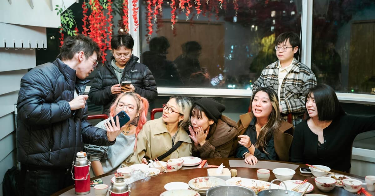 chinese family gathering - group of friends around a table for a meal
