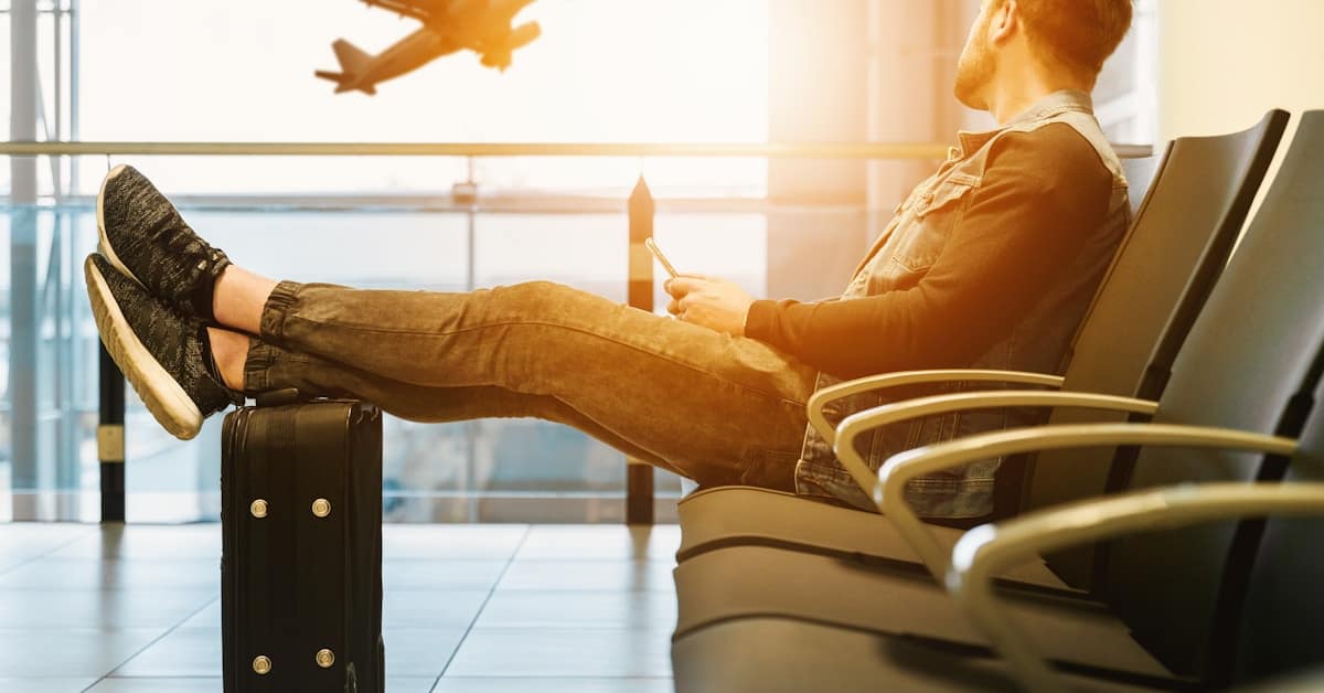 china esim vpn - traveler at airport with phone and luggage