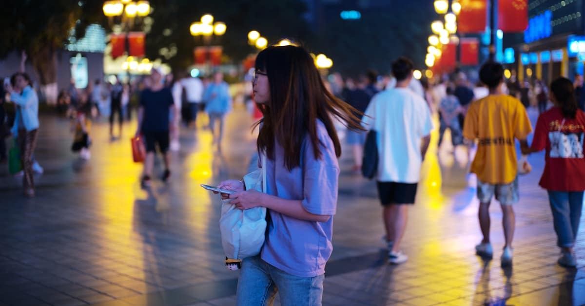 china navigation apps - woman walking in city at night