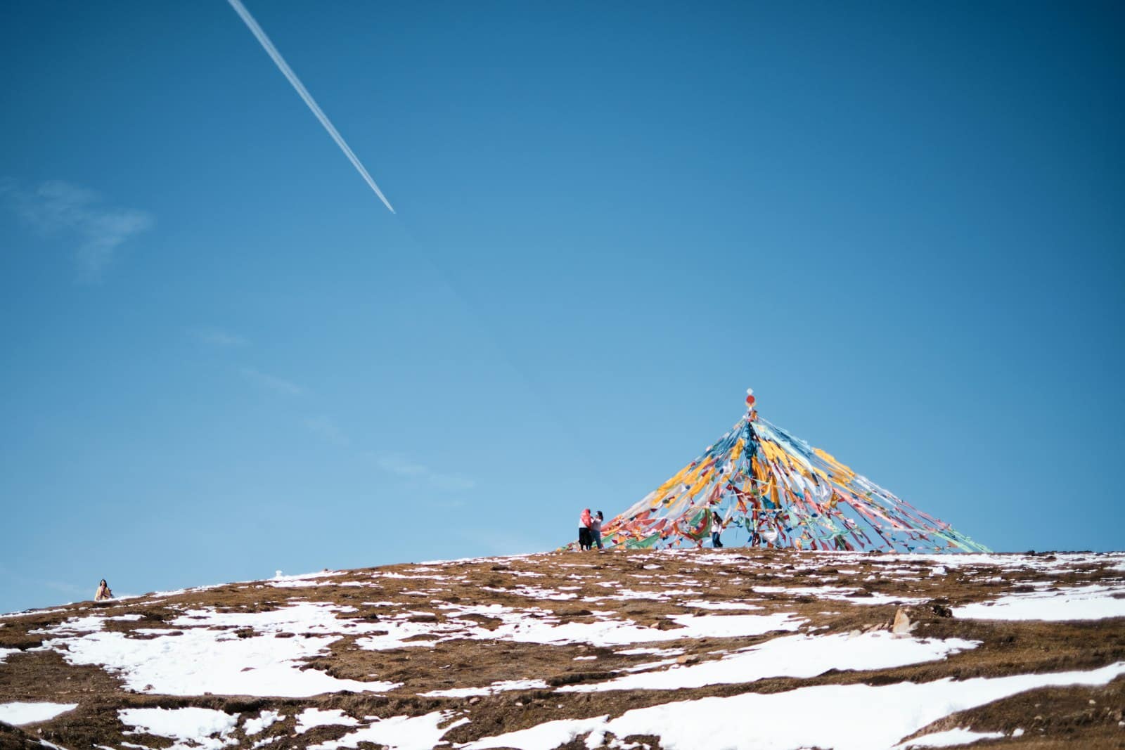 tibet permit 2026 - a hiker on a Tibetan ridge with cloudy mountain backdrop