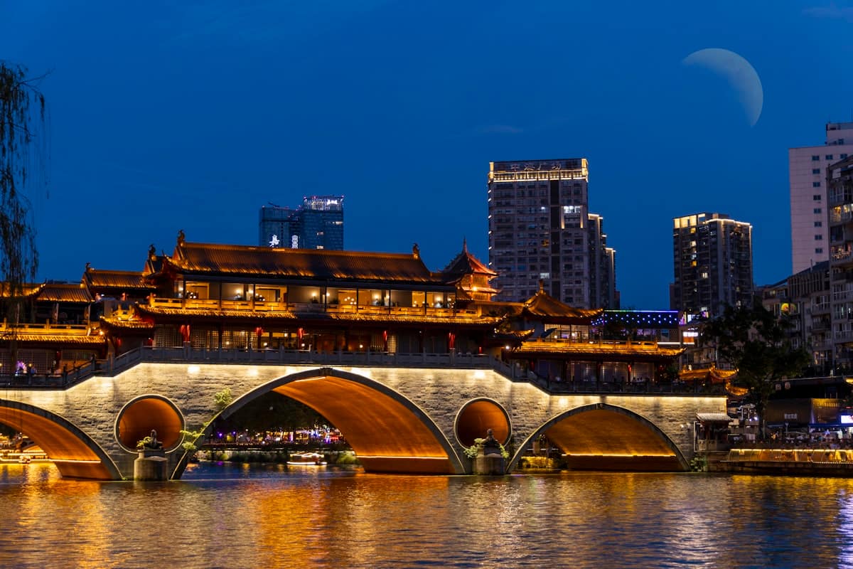 china in september - chengdu bridge over water traditional buildings