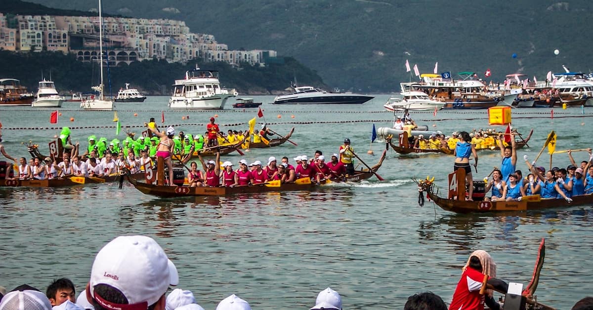 dragon boat festival - spectators watching racing teams on the river